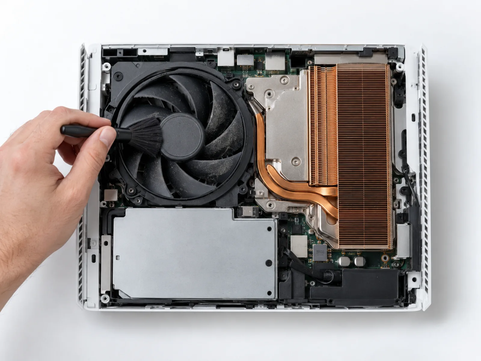 Xbox Series X fan and heatsink being cleaned